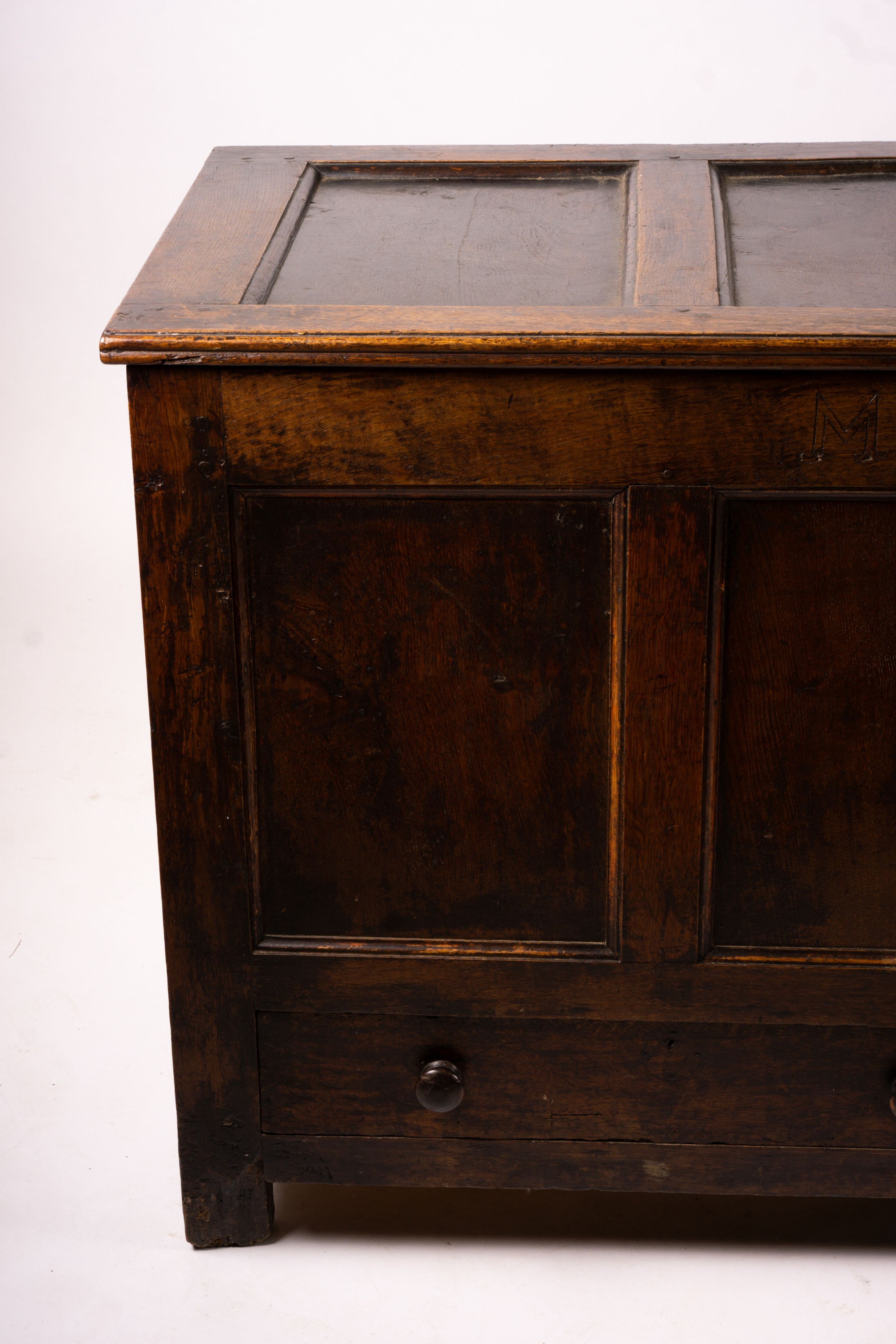 An 18th century panelled oak mule chest, length 161cm, depth 61cm, height 84cm